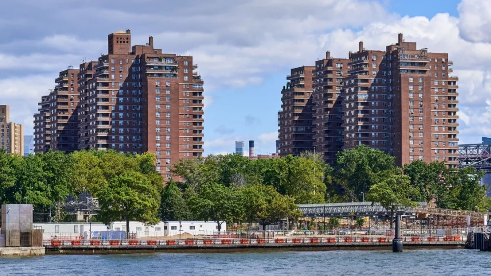 Towers of the East River Co-ops (1956) in the Lower East Side, NYC. In the foreground is the East River and East River Park under renovation.New York, NY - August 13, 2022