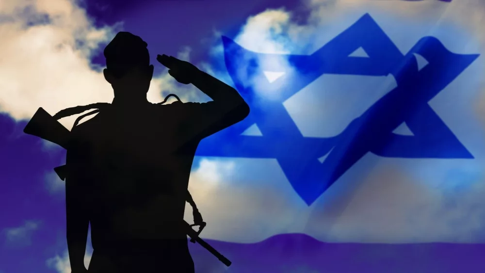 Israeli soldier with rifle, silhouette on the background sky with smoke and flag of Israel. Concept: War, IDF, Defense