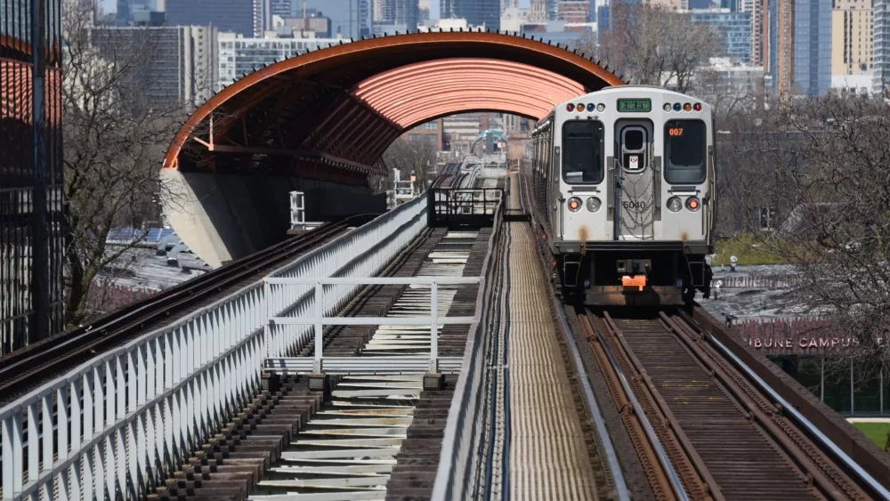 CTA Chicago Transit Authority elevated train tracks with green line train going through the tunnel above the Illinois Institute of Technology McCormick Tribune Campus Cente. Chicago, IL April 20, 2020