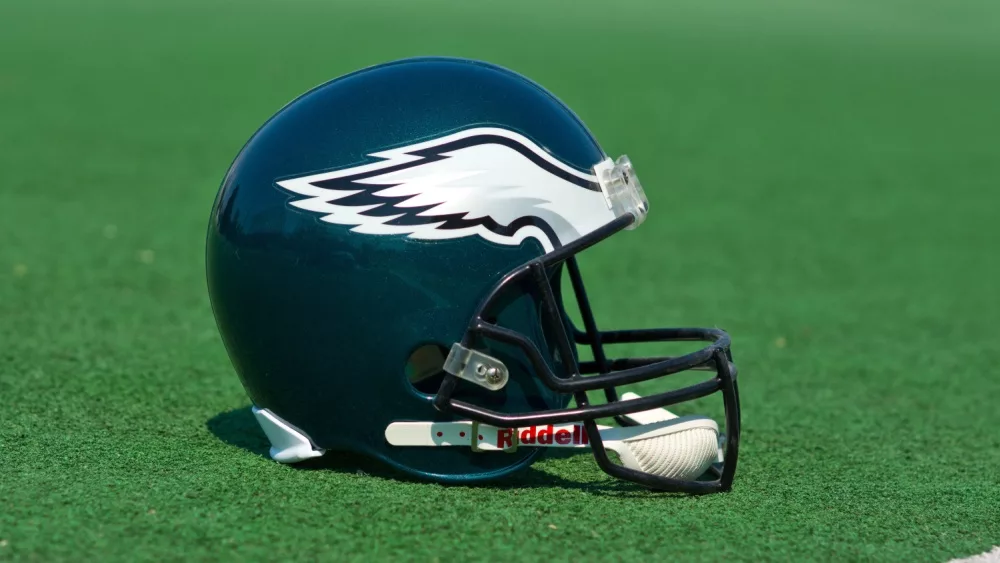 Philadelphia eagles NFL club helmet on the green playing field , product shot