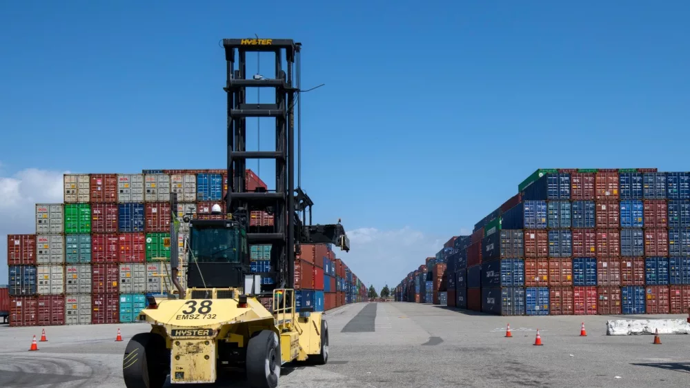 Port of Los Angeles - Port of Long Beach, CA. Stacked shipping containers and forklift. 2024 May 3