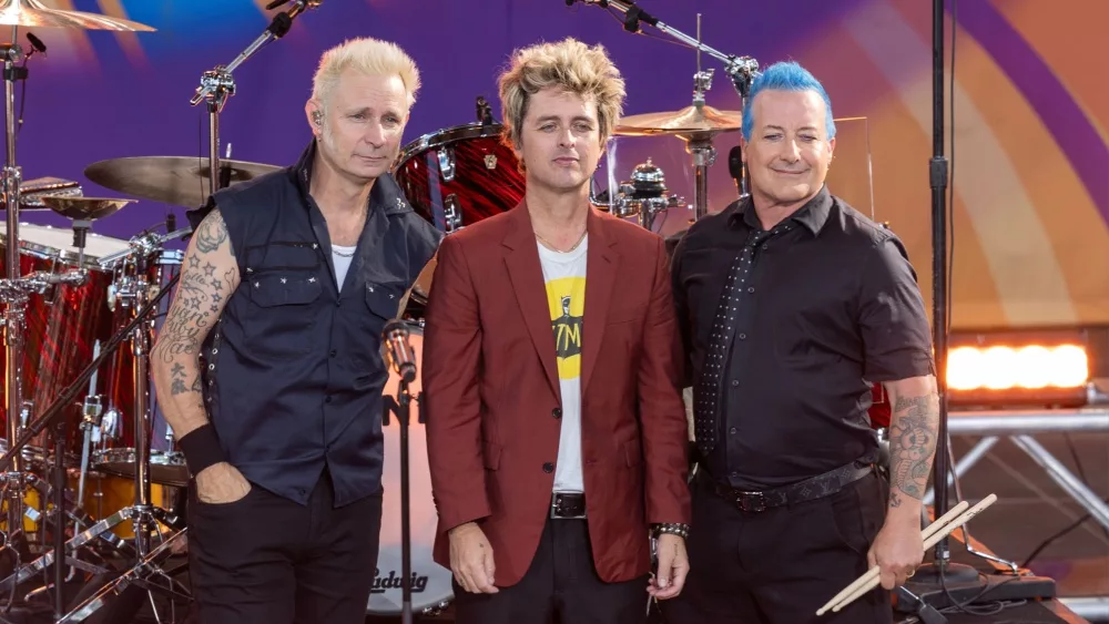 Mike Dirnt, Billie Joe Armstrong, Tre Cool pose on stage during ABC Good Morning America rock group Green Day concert in Central Park in New York on July 26, 2024