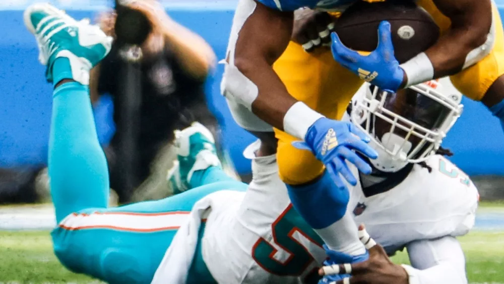 Dolphins linebacker Jerome Baker (55) tackled by Los Angeles Chargers running back Austin Ekeler (30) during an game, Sept. 10, 2023, in Inglewood, Calif.