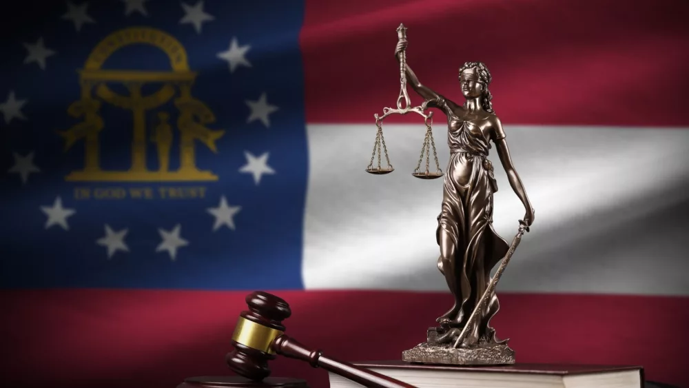 Georgia US state flag with statue of lady justice, constitution and judge hammer on black drapery