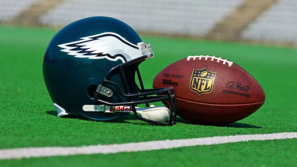 Philadelphia eagles equipment , ball and helmet on the green playing field , product shot