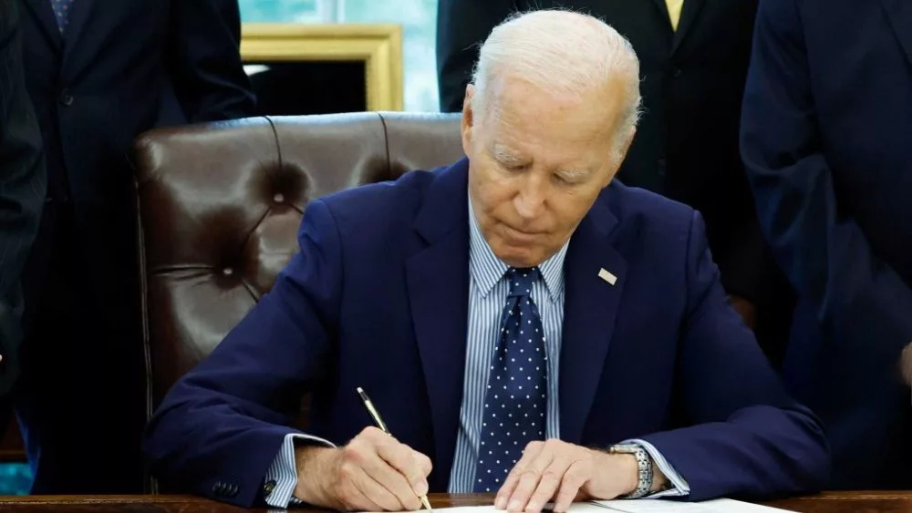 U.S. President Joe Biden signs a proclamation in the Oval Office of the White House. WASHINGTON, DC - AUGUST 16