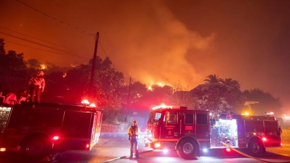 Firefighters battle the Eaton fire as its burns in Sierra Madre, east side of Los Angeles, California, Wednesday, Jan. 8, 2025..