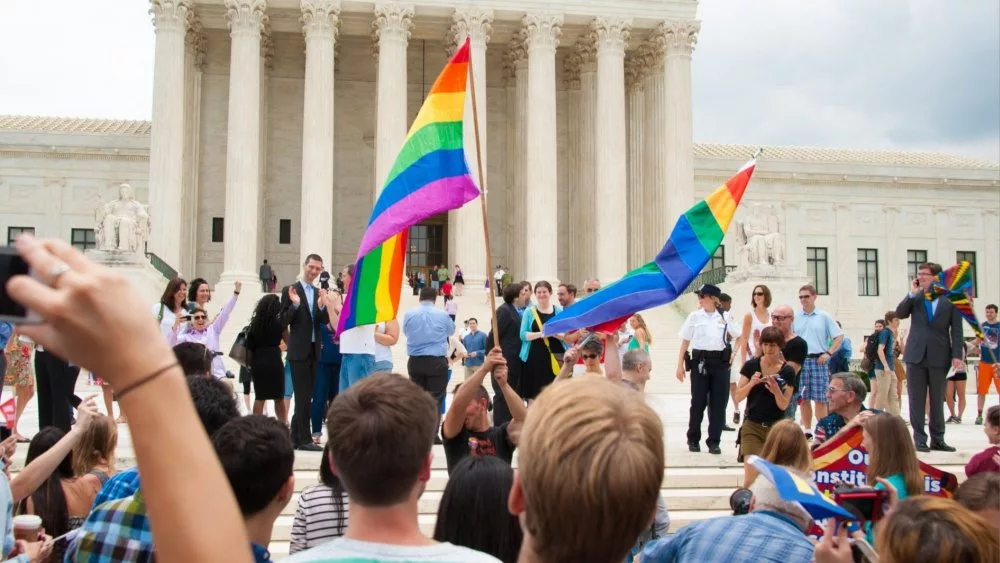 Crowd waving flags in support of LGBTQ community gathers at the U.S. Supreme Court ; WASHINGTON June 26, 2015