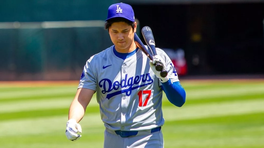 Los Angeles Dodgers designated hitter Shohei Ohtani walk on the field before a game against the Oakland Athletics at the Oakland Coliseum. Oakland, California - August 4, 2024