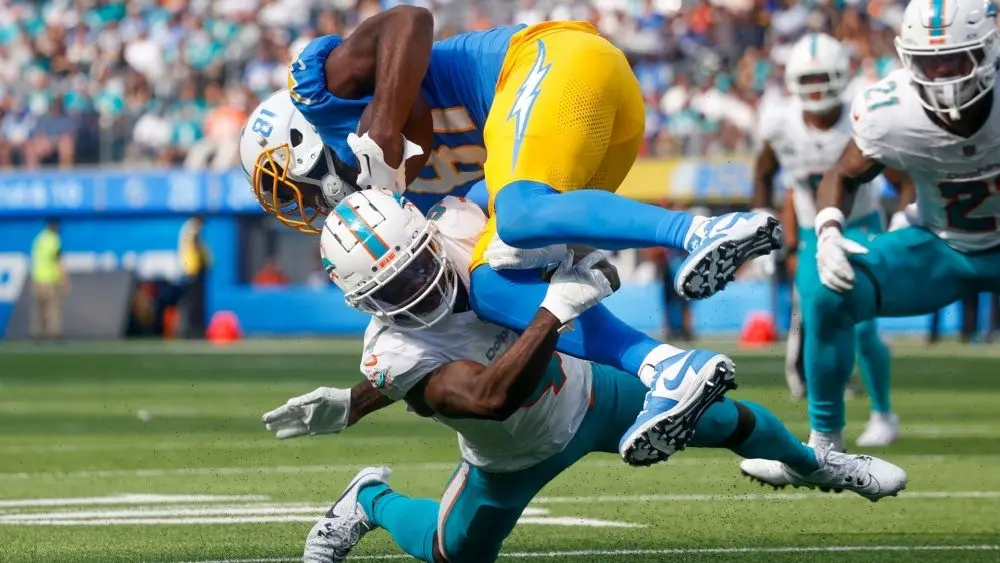 Los Angeles Chargers wide receiver Mike Williams (TOP) is brought down by Miami Dolphins cornerback Kader Kohou (BOTTOM) during an NFL football game, Sept. 10, 2023, in Inglewood, Calif.