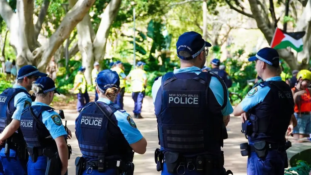 Crime in Sydney Australia. Close up of a NSW Police officers uniform sleeve patch and his communication device. Sydney, NSW Australia - October 6 2024