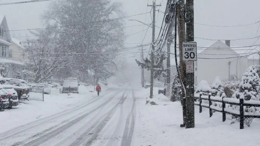 Person is walking in snow storm day on North Taylor Avein Norwalk NORWALK, CT, USA -FEBRUARY 7, 2021