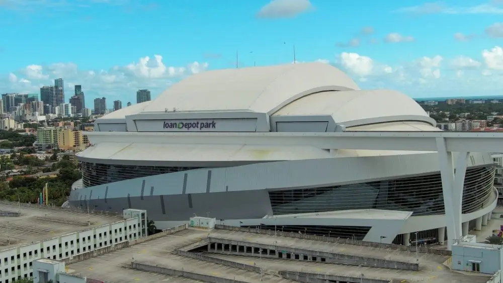 Aerial shot of LoanDepot Park with skyscrapers and office buildings in the city skyline, lush green palm trees and cars on the street in Miami Florida USA Miami Florida USA - 11 -12-2024