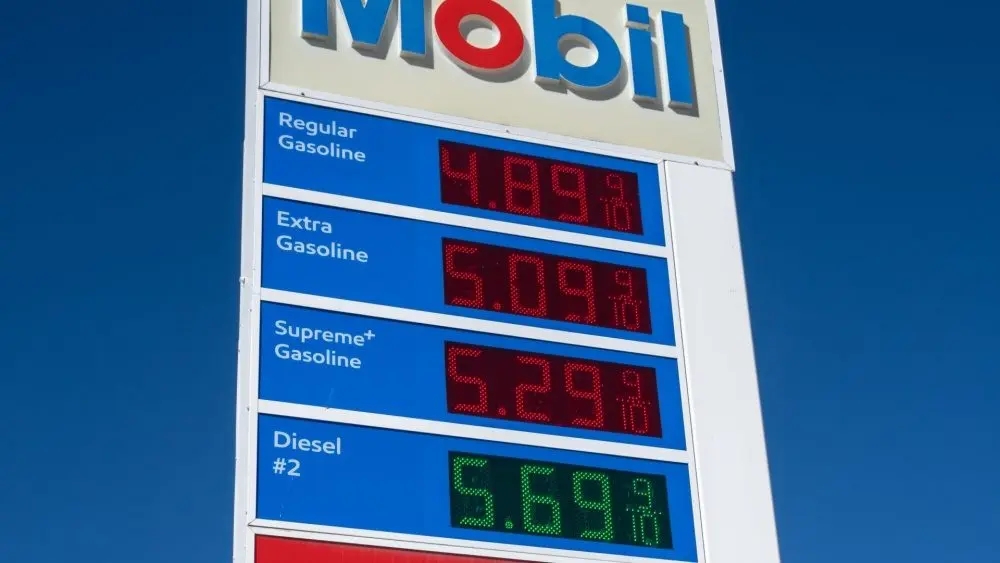 Mobil gas station sign showing high price of California Gasoline with bright blue sky Lone Pine, CA, USA - February 9th, 2023