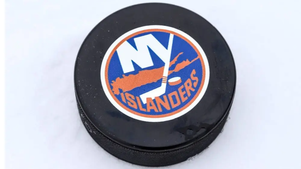 New York Islanders logo on Ice hockey puck outdoors in snow OREBRO, SWEDEN - FEBRUARY 3, 2019