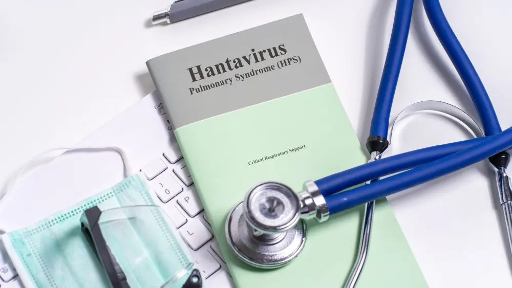 Hantavirus Pulmonary Syndrome (HPS) Critical Respiratory Support booklet with stethoscope, mask and clinical desk setup.