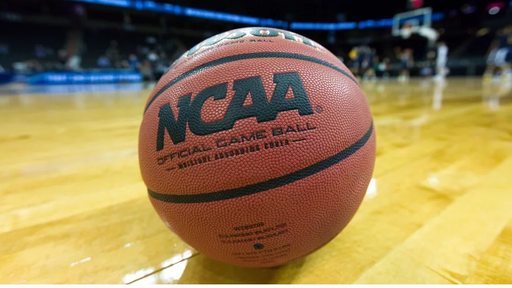 NCAA basketball/game ball sits on court