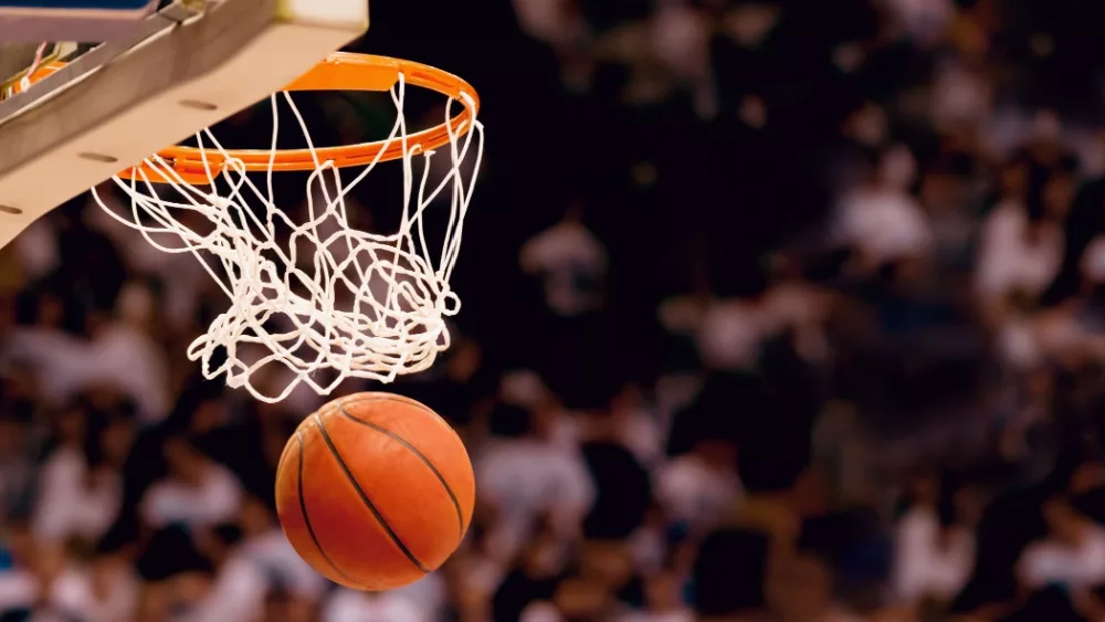 Image of basketball hoop/net with basketball going through/Scoring the winning points at a basketball game