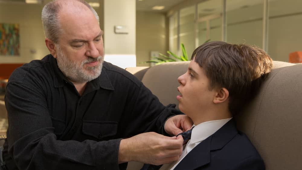father-helping-his-son-with-disabilities