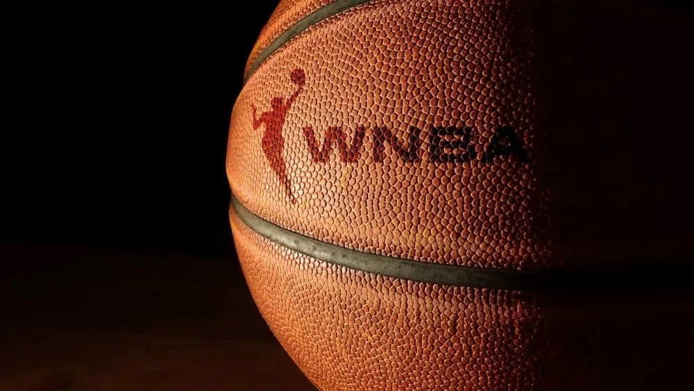 Closeup of a basketball with the WNBA logo and text