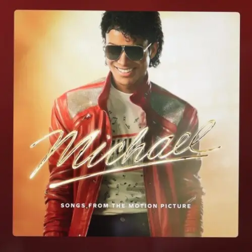An Apple iPad displays the Spotify music player featuring the artist Michael Jackson's album "Michael: Songs from the Motion Picture"