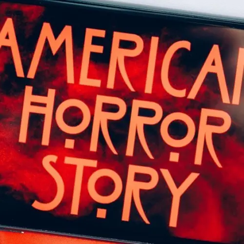 Screensaver with the 'American horror story' logo on a smartphone on toned background