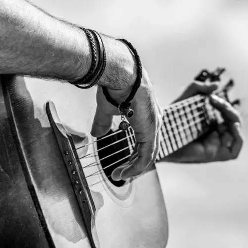 Acoustic guitars playing. Music concept. Black and white. Male musician playing guitar^ music instrument. Man's hands playing acoustic guitar^ close up.