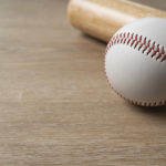 close-up-baseball-and-baseball-bat-on-wooden-table-background-s