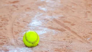 old-softball-in-a-softball-field-in-california-mountains-on-a-wh