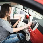car-dashboard-radio-closeup-woman-sets-up-radio