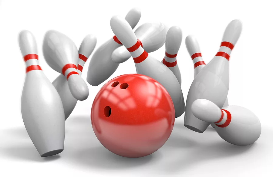 red-bowling-ball-knocking-over-pins-in-a-perfect-strike
