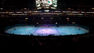 pro ice hokey rink lit up at nighttime