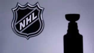 National Hockey LeagueLogo of NHL club on the screen. Stenley Cup Trophy Silhouette.