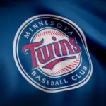Close-up of waving flag with Minnesota Twins MLB baseball team logo^ seamless loop. Editorial footage