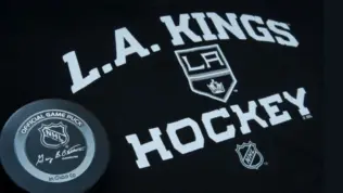 Official NHL game puck with LA kings equipment ^ product shot