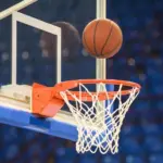 A basketball flying into the basket