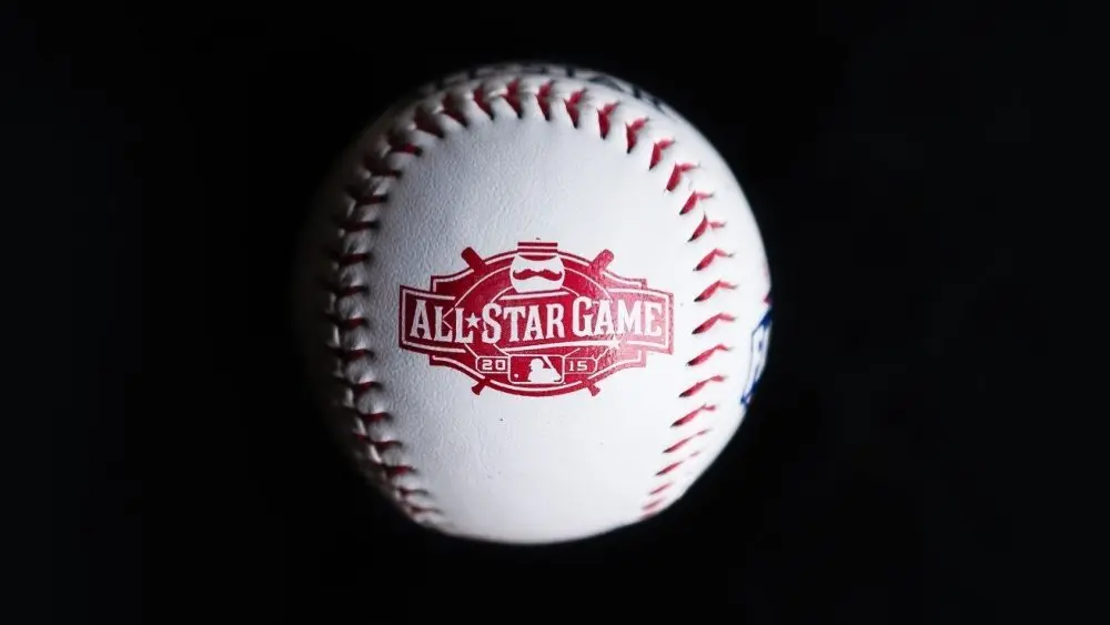 Close up baseball printed with logo for the 2015 Major League Baseball All-Star Game isolated on a dark black background. Cincinnati^ Ohio^ USA - July 21 2022