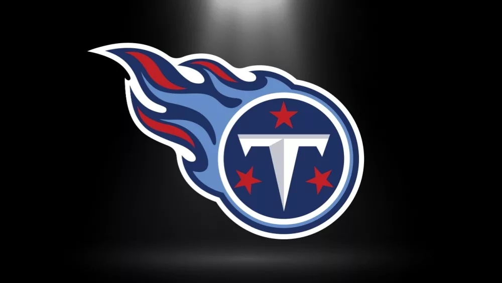 Tennessee Titans logo^ NFL Team^ based in Nashville^ south division^ Superbowl^ with spotlight background