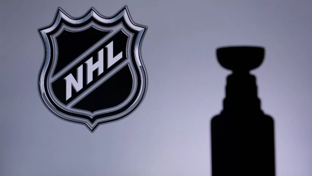 National Hockey LeagueLogo of NHL club on the screen. Stenley Cup Trophy Silhouette.