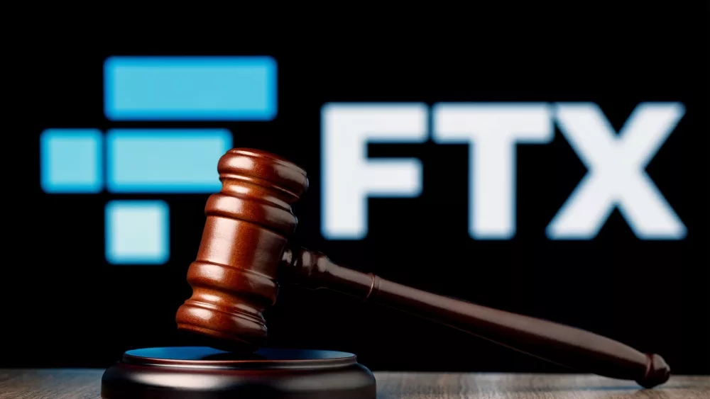 FTX is cryptocurrency exchange. Gavel on table against background of FTX logo.