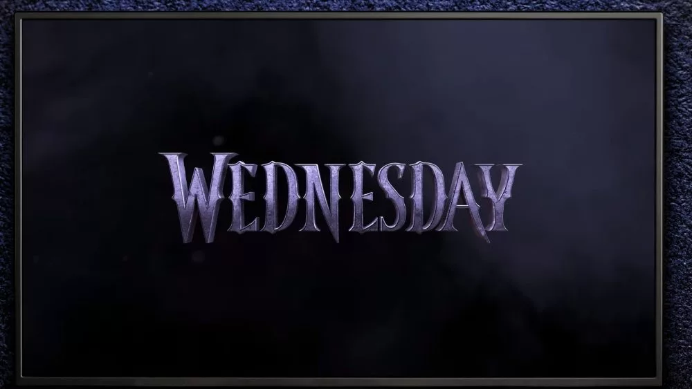 TV on black wall. TV screen playing Wednesday trailer or movie. Moscow^ Russia - December 5^ 2022.