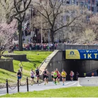 Runners in the Boston Marathon pass the 1 kilometer to go line on their way to the finish line