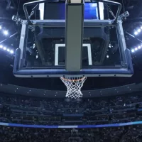 Brightly lit Basketball backboard in a large sports arena.