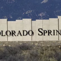 Colorado Springs city entry monument with Pikes Peak in the background. Colorado Springs^ CO