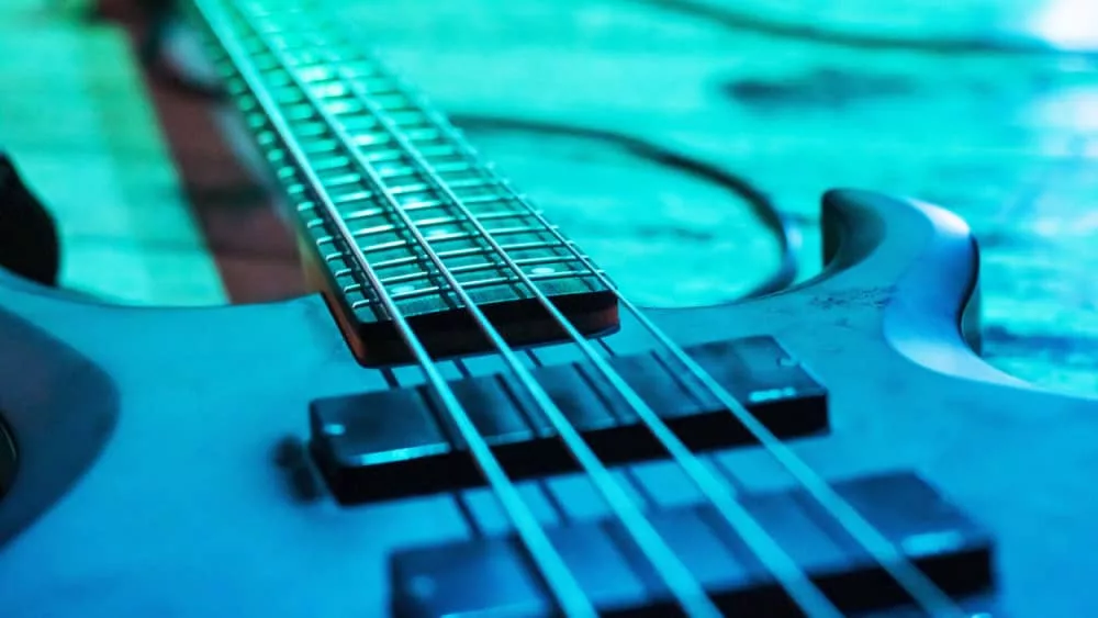 Electric guitar on the floor in blue lighting close up