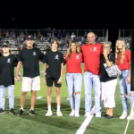 Karnes-number-retired-pic: Jason Karnes is joined by his family on Van Metre Field as Du Quoin retires his #12 jersey.