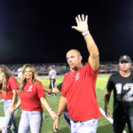 Karnes-pic_1.10.1: Jason Karnes waves to the crowd after having his #12 jersey retired at Du Quoin High School.