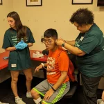 Special Olympics Summer Games: All of the athletes visited Healthy Athletes! They received Gatorade drink packs for water, bandanas, and fruit at the Hydration Station. They received dental and hearing screenings at Special Smiles and Healthy Hearing Stations. They also received vision exams at the Healthy Eyes Station. Preston and his parents picked out prescription sports googles for him to wear while playing basketball this coming year. All for FREE!!!! (Submitted by Megan Clodi)