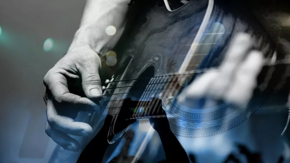 country artist/Guitarist with the audience in a double exposure