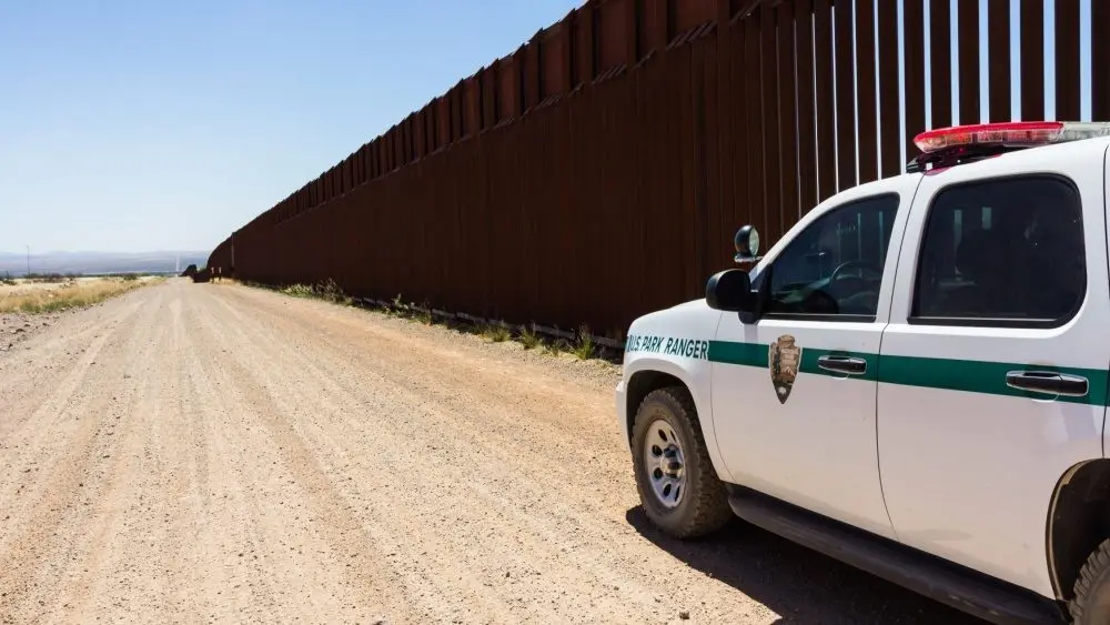 Police car stopped near the border fence of the USA . Arizona^ USA - June 28^ 2016